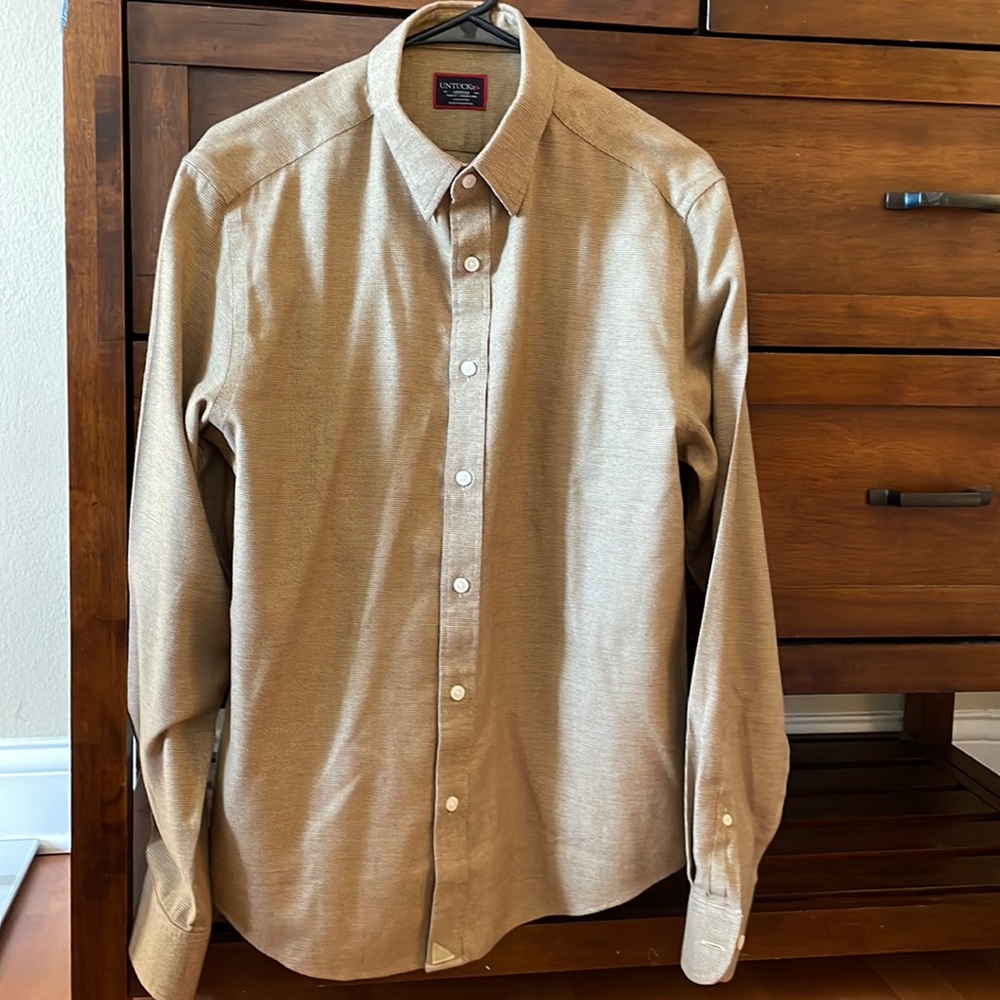 Medium untuckit shirt in a gold color.